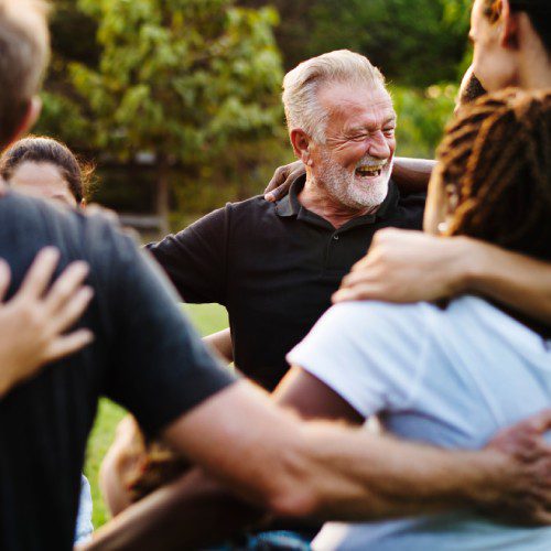 A group of people embracing each other in a circle.